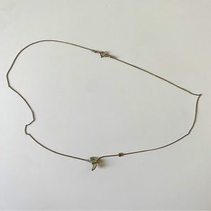 Dainty gold necklace with moonstone details.